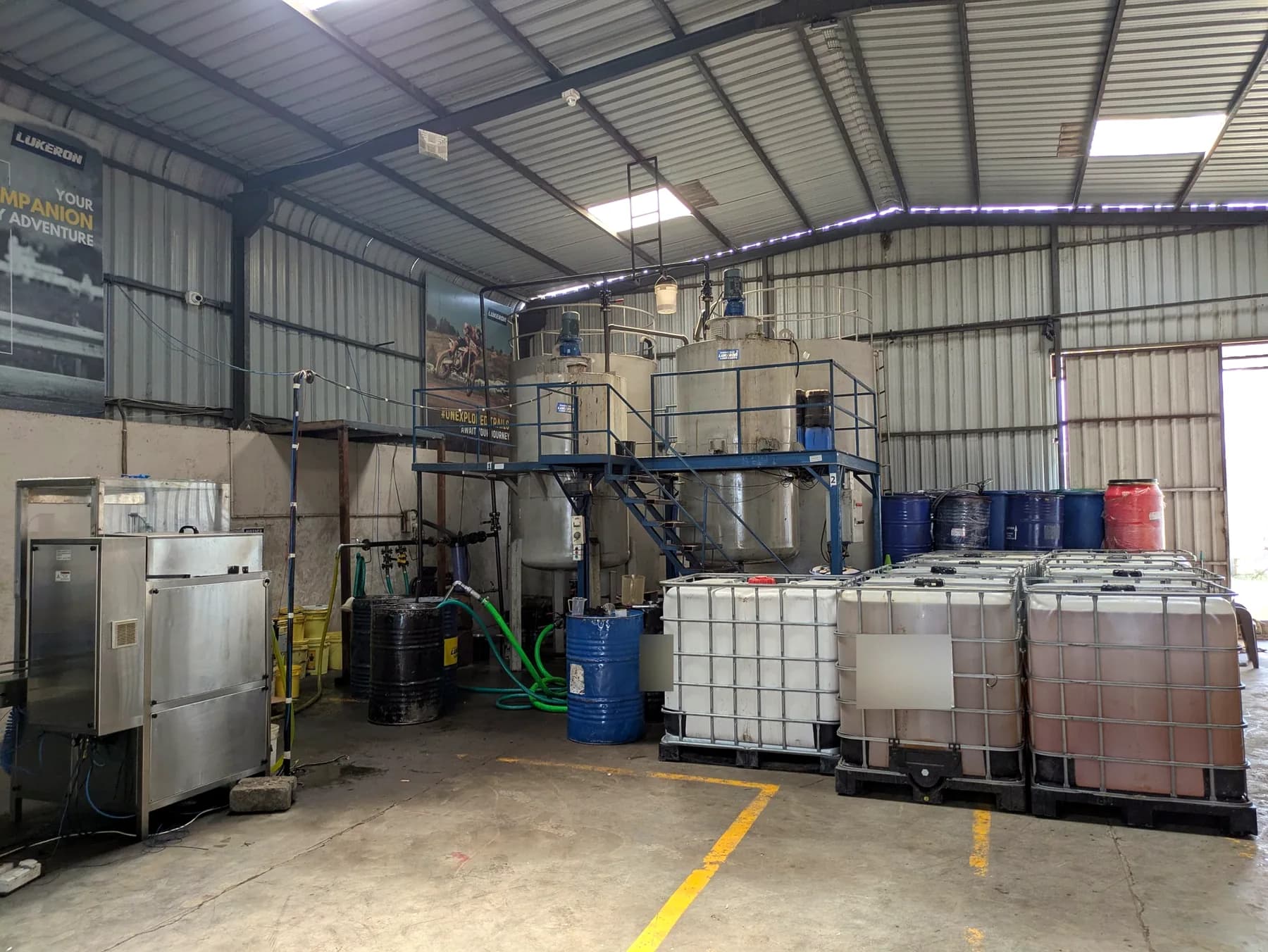 Blending hall at the Lukeron plant with blending tanks, drums and storage totes