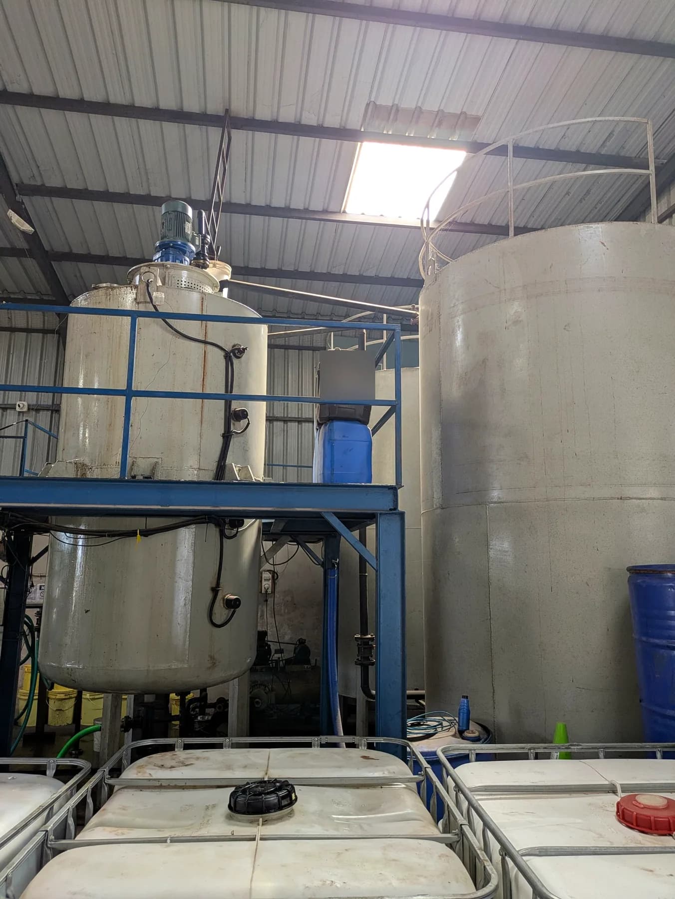 Close view of two blending tanks and storage totes at the Lukeron plant