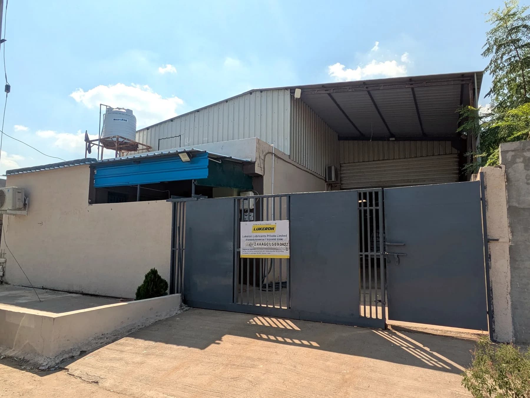 Entrance of the Lukeron Lubricants plant at Anandpar, Jamnagar, with the company name board on the gate